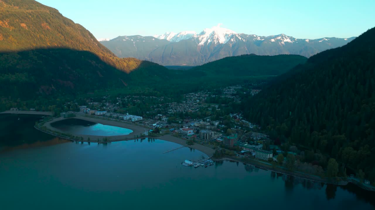 aerial shot over harrison hot springs at sunset with the cheam peak mountain in the background, Fraser Valley, British Columbia, Canada