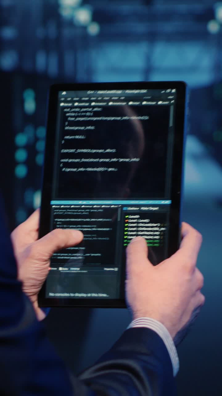 Vertical video: Support specialist checking server computers on tablet