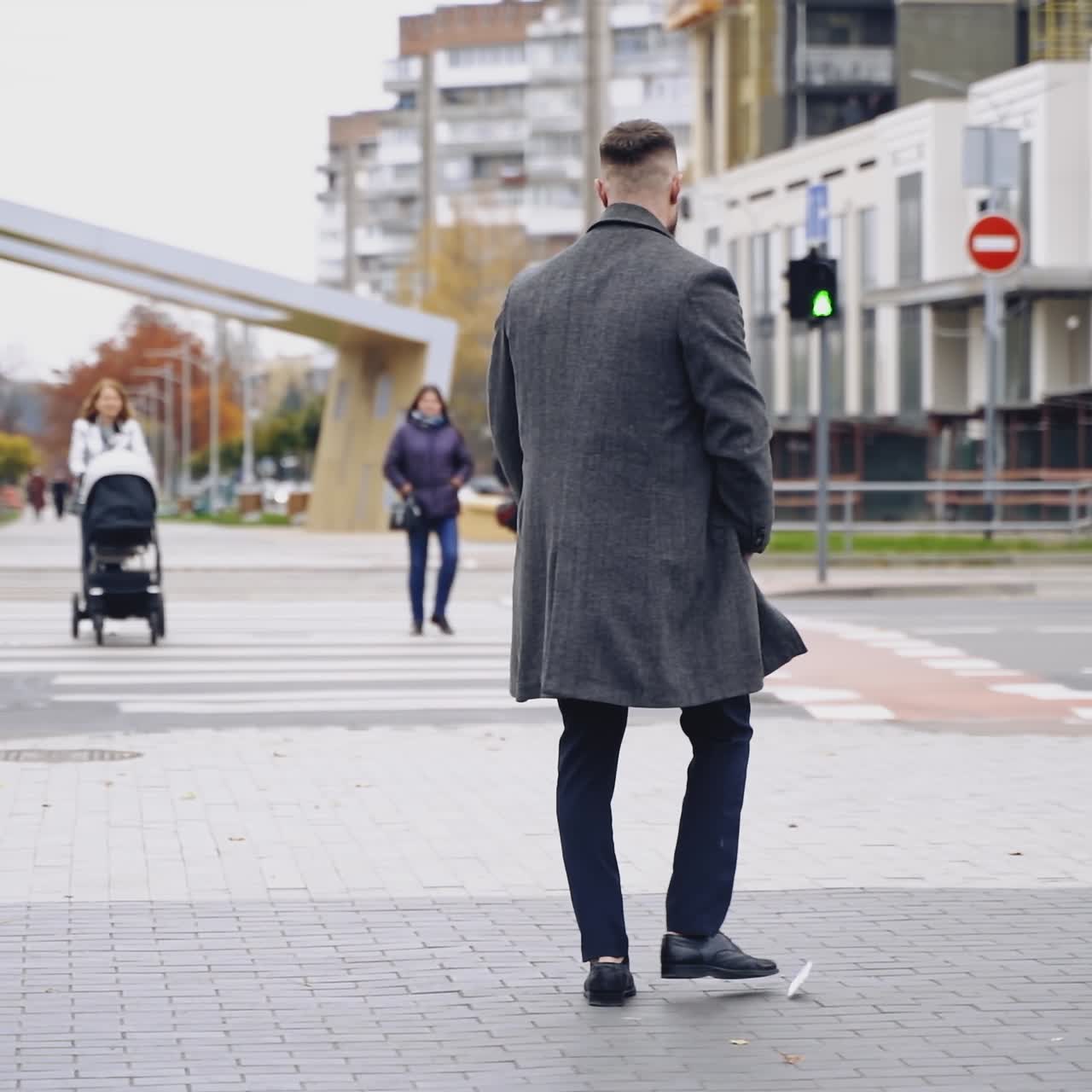 Nervous businessman talking on phone in the city. Annoyed man using mobile phone and breaking it on asphalt in the street city. Slow motion.
