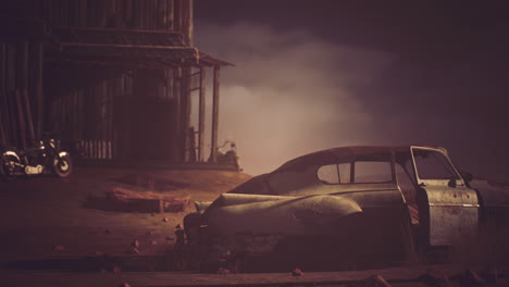 abandoned vintage car beside a rustic barn at dusk in a rural setting