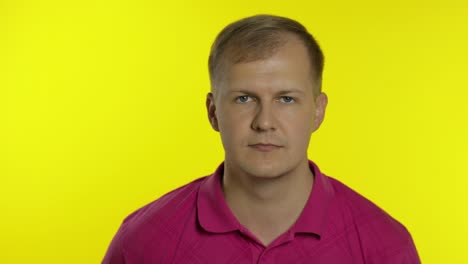 Portrait of caucasian man posing in t-shirt. Smiling handsome guy show OK sign. People emotions
