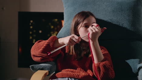 girl knitting at home