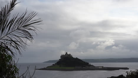 view from a terrace in marazion of the english medieval castle and church of st michael's mount in cornwall on a cloudy spring day