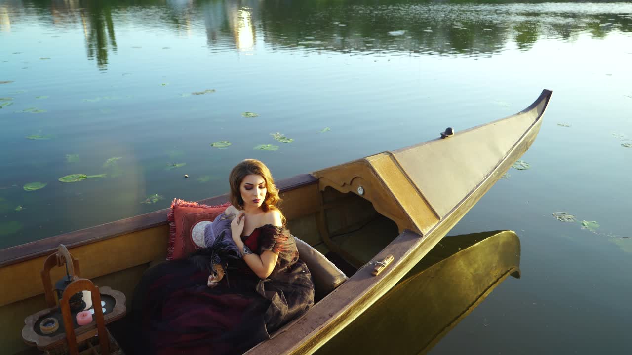 Young woman in gondola in Venice. Woman with a carnival mask