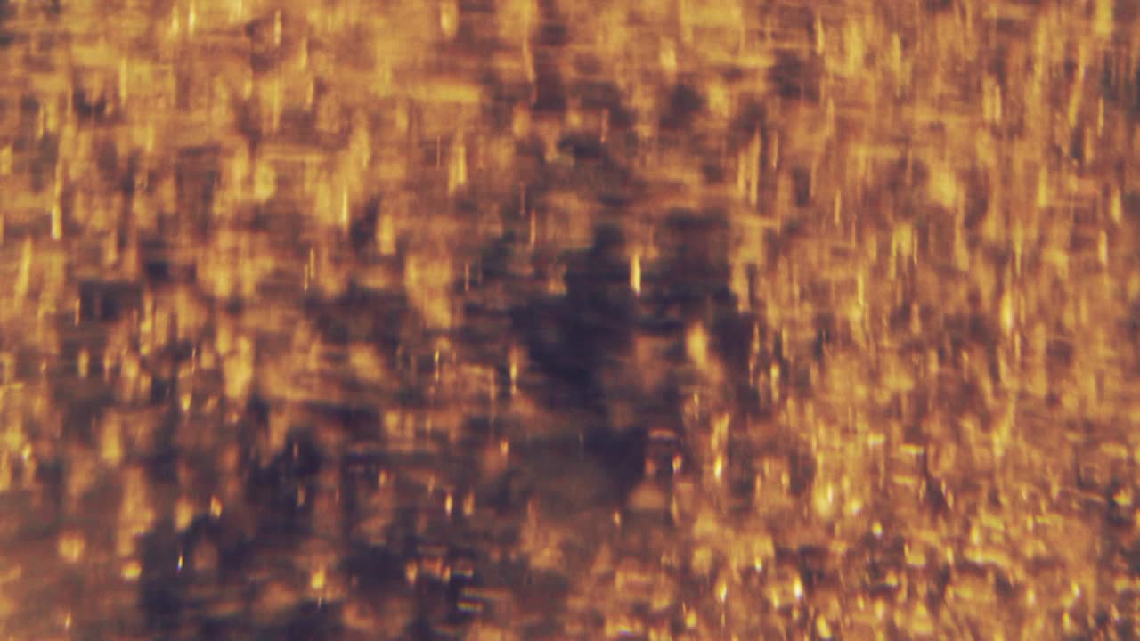 partículas doradas abstractas con borroso desfocado bokeh se mueve caos, copos de nieve