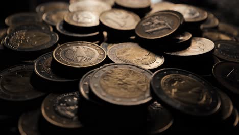 stack of euro coins in shadowed light, highlighting metallic details and value