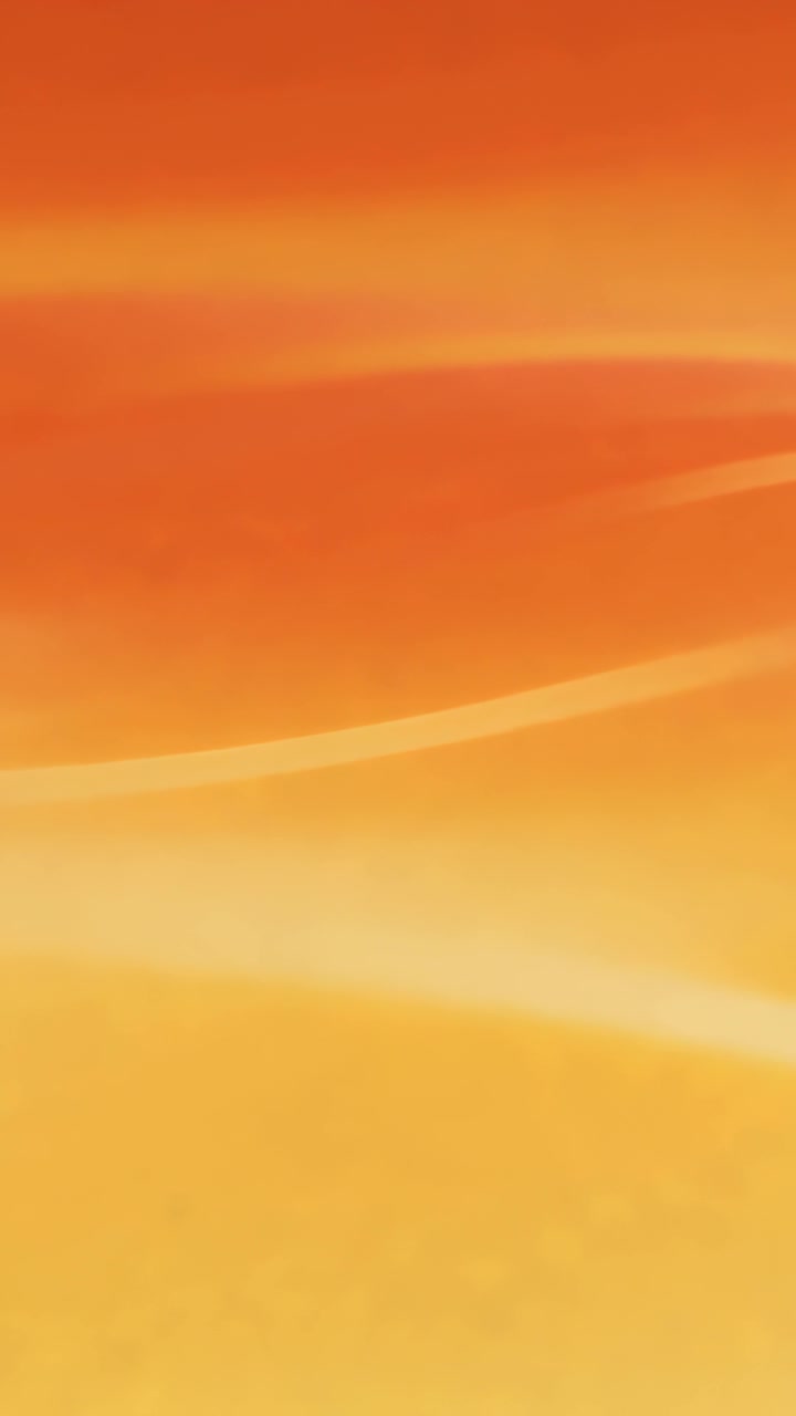Vertical video: Looping orange-to-yellow gradient subtly shifting as backdrop with soft bands