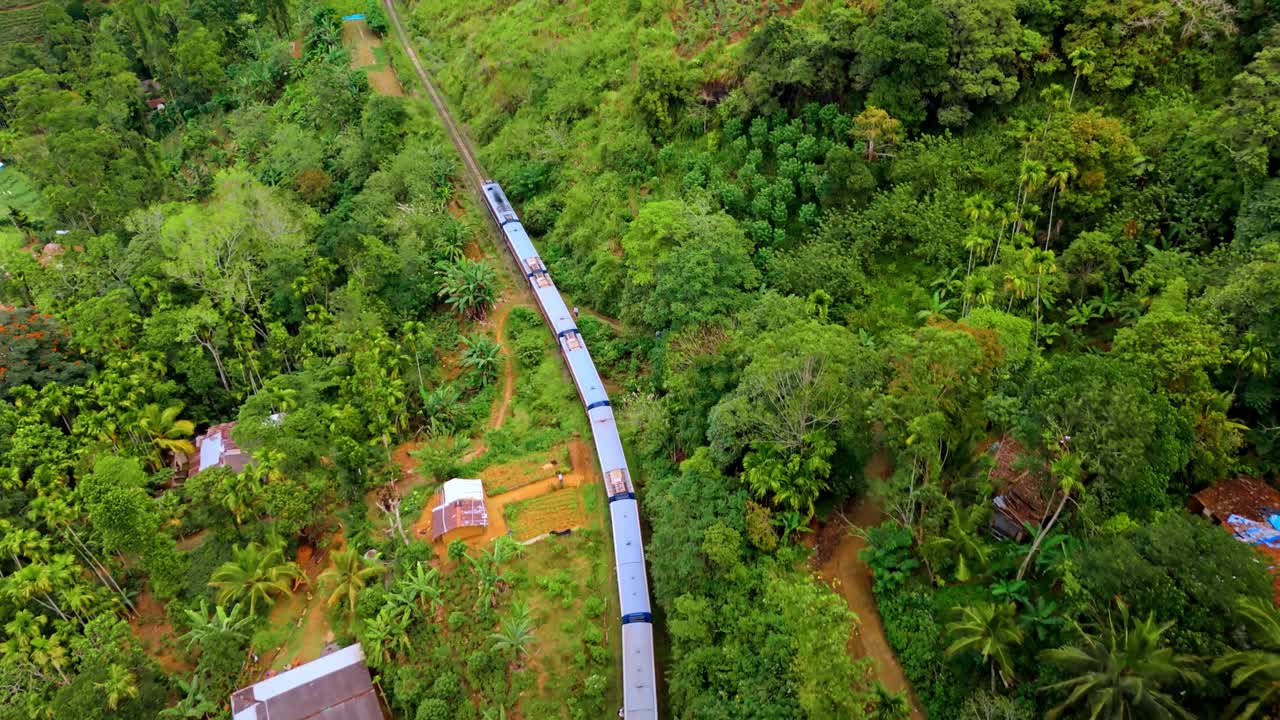 Captivating aerial drone footage of a train crossing the iconic railway bridge in Ella, Sri Lanka.