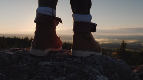 The-Traveler\'s-Feet-At-The-Top-Of-The-Peak-Through-Them-Shines-The-Rising-Sun-And-Beautiful-Landscap