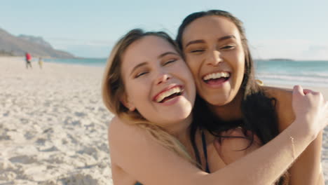 beautiful woman hugging girl friend on beach giving suprise kiss on cheek best friends having fun summer vacation