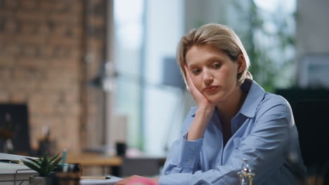 upset manager finish laptop work sitting workplace close up. unmotivated woman