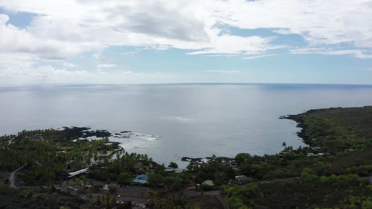 Close-up panning aerial shot of Pu'uhonua O Honaunau National Historical Park and Honaunau Bay on the leeward coast of Hawai'i