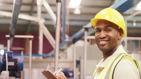 Worker-examining-while-writing-on-clipboard