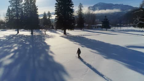 Hiker-walking-on-a-snowy-landscape-4k