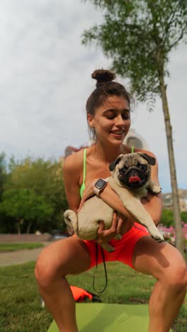 woman with a pug in a park
