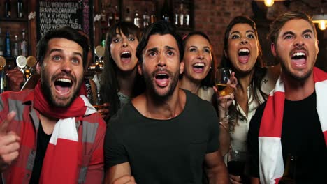 Group-of-friends-watching-tv-in-bar