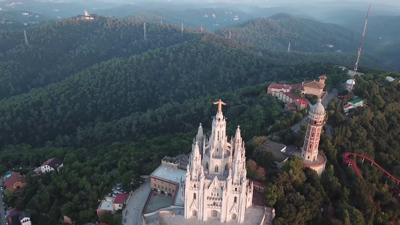 drone shot over tibidabo in Barcelona 4k, jesus christ statue in barcelona