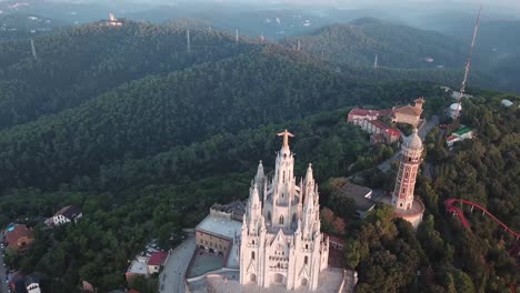 drone shot over tibidabo in barcelona 4k, jesus christ statue in barcelona