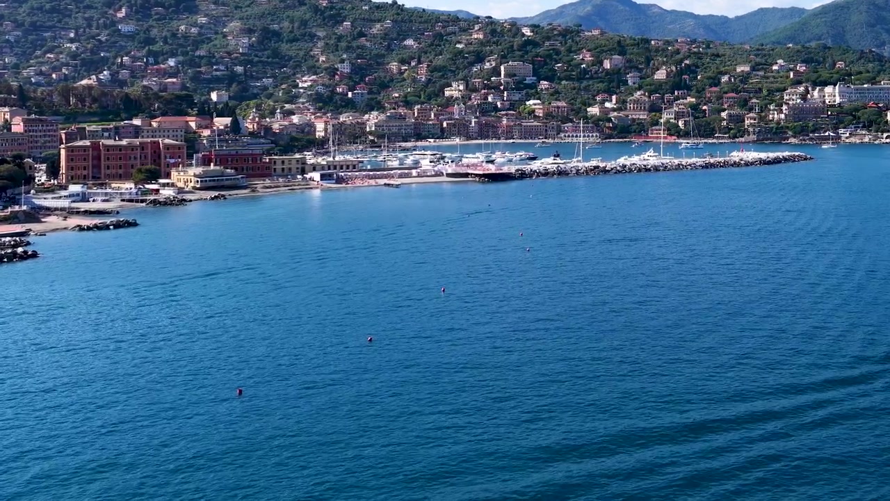 Ampia vista aerea cattura un colorato villaggio costiero adagiato lungo il blu Mar Mediterraneo