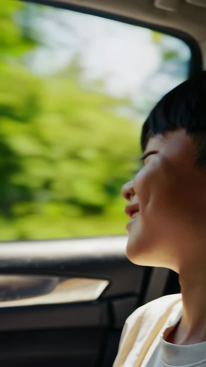 A child looking out of a car window during a journey