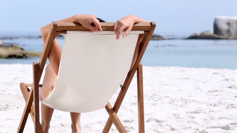 Woman-sitting-and-tanning-on-a-chair-