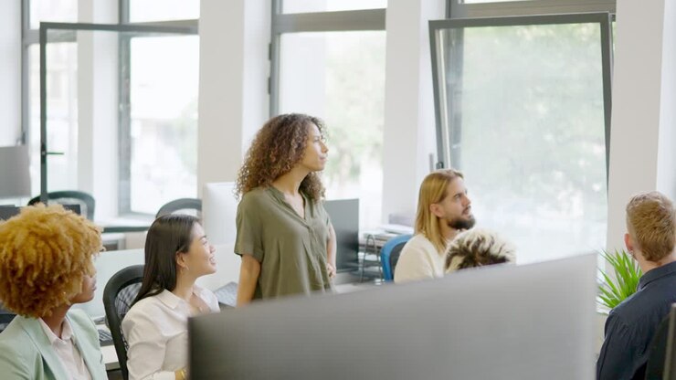 Multi-ethnic coworkers listening to the manager in a business meeting