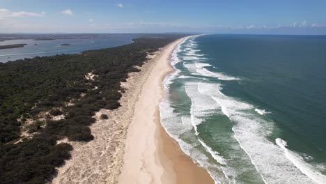foamy ocean waves splashing at south stradbroke island, queensland, australia - drone shot
