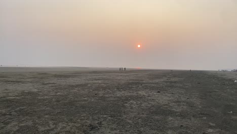 Slow-motion-shot-of-sunset-view-in-the-beach-side-of-Kolkata-with-people-at-a-distant