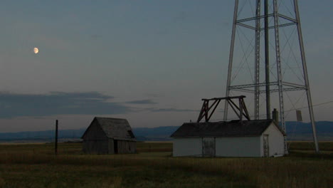 a water tower stands in a small prairie town