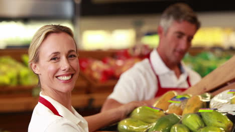 Smiling-workers-stocking-vegetables