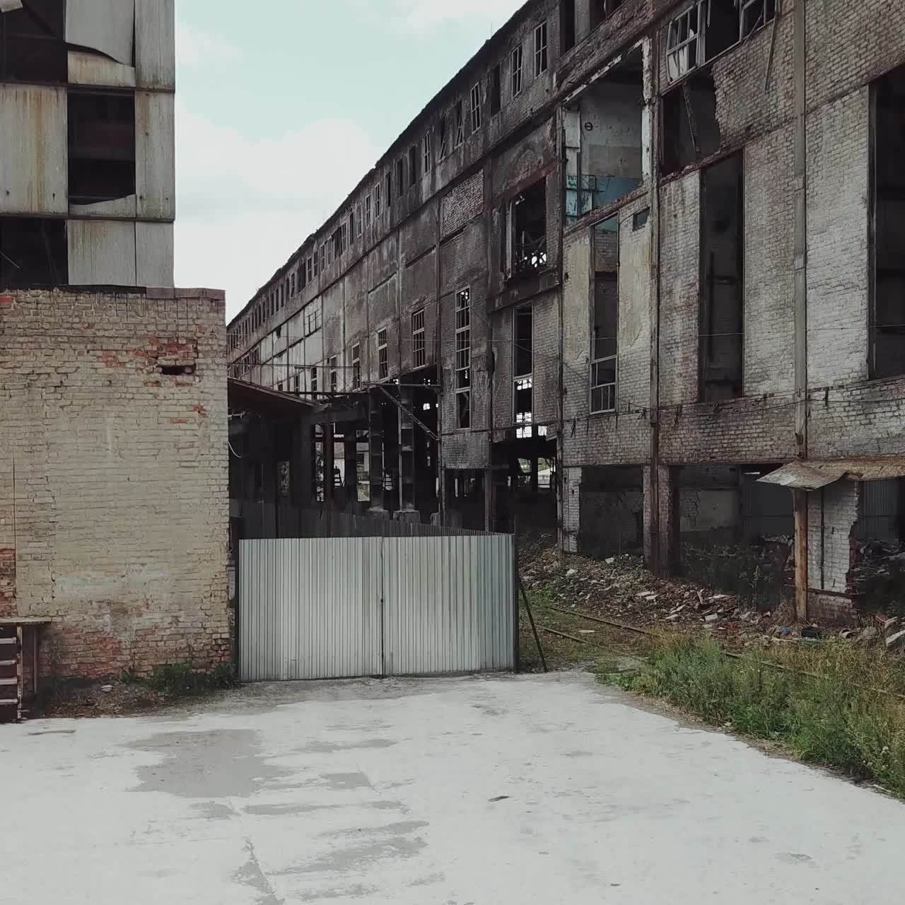 Take-off of the drone at an abandoned factory. Old abandoned factory building. Aerial View