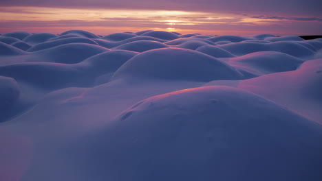 snow dunes at sunset
