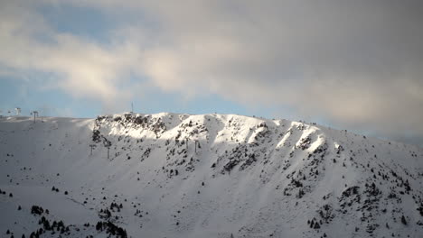 empty ski lift passing through beautiful snow covered andorra winter mountains scenery