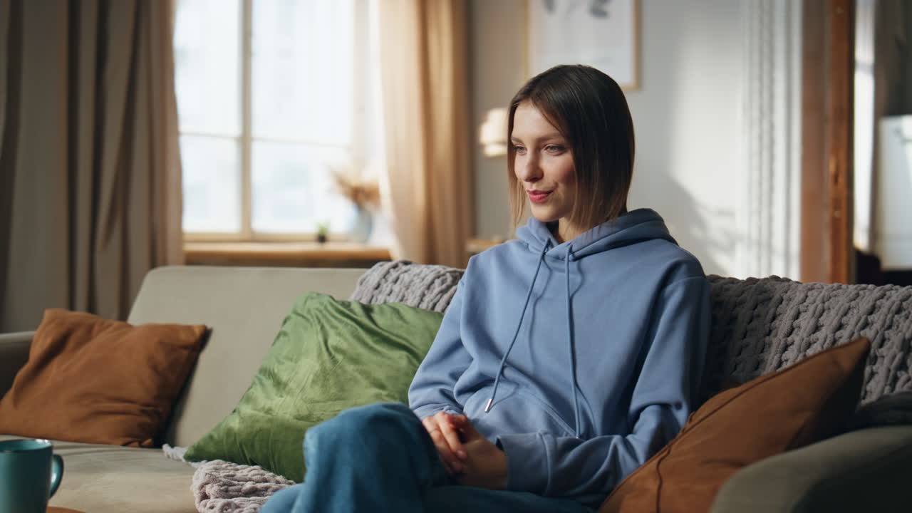 Woman sitting on couch in living room