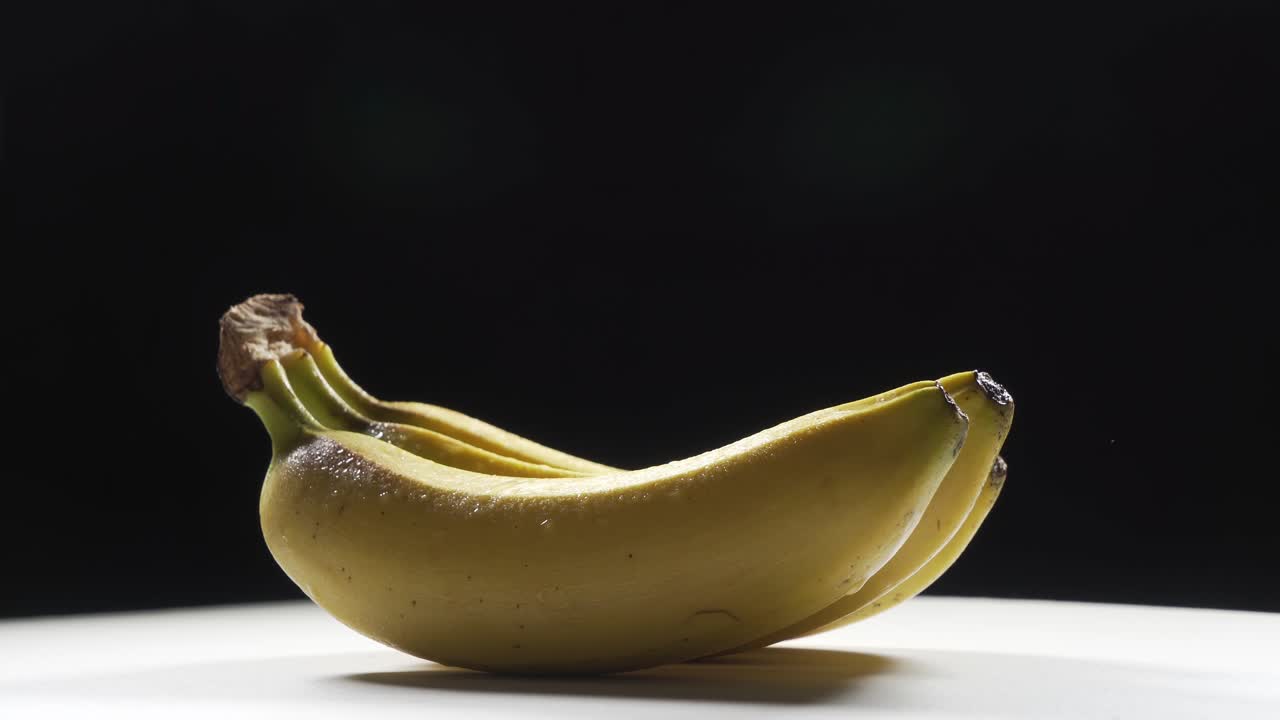 Three Banana Bunch Rotating On black