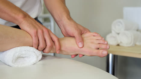 physiotherapist giving foot massage to a female patient