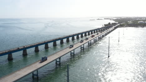 dump trucks driving down the 7 mile bridge in the florida keys