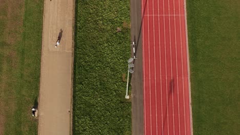aerial view looking down over sporting preparation on red athletics running track at parliament hill