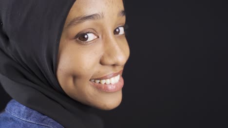 muslim african young woman in hijab with white shiny teeth.