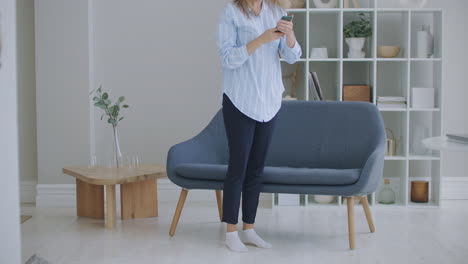 Funny-euphoric-young-woman-customer-celebrating-winning-bid-or-getting-ecommerce-shopping-offer-on-smartphone.-Excited-girl-winner-looking-at-mobile-phone-using-app-celebrating-success-concept.