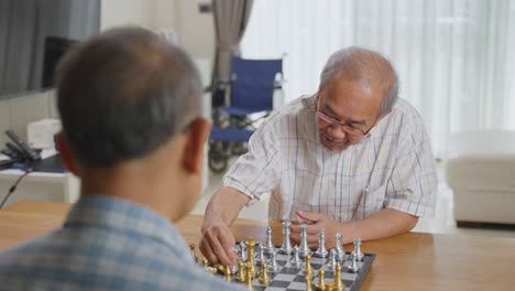 two elderly men playing chess at home