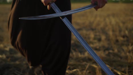 a cossack with two sabres in his hands looks into the distance at the enemy 05