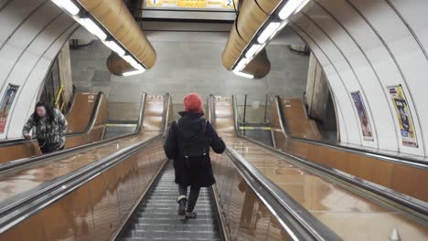 girl going down escalator in prague czech republic