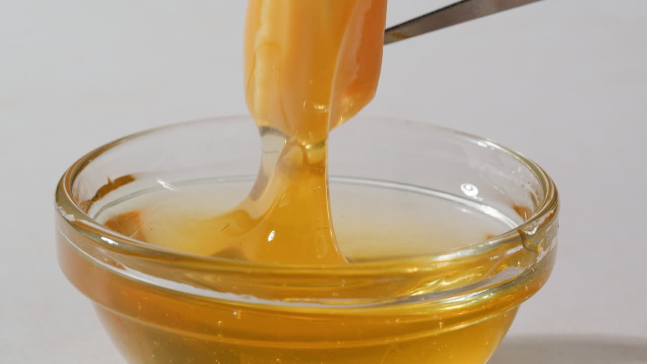 Honey in a Glass Bowl with Fork