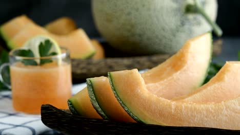 whole and sliced of japanese melons,honey melon or cantaloupe (cucumis melo) glass of melon smoothie healthcare concept.