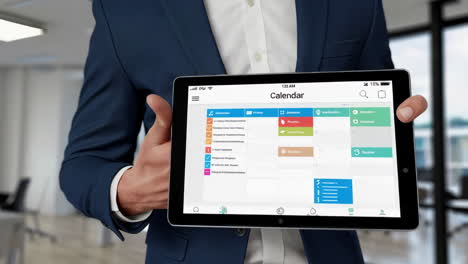 man using digital calendar application on tablet