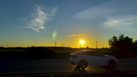 cars driving through a highway overlooking beautiful sunrise in clear morning sky of koleczkowo poland - wide shot