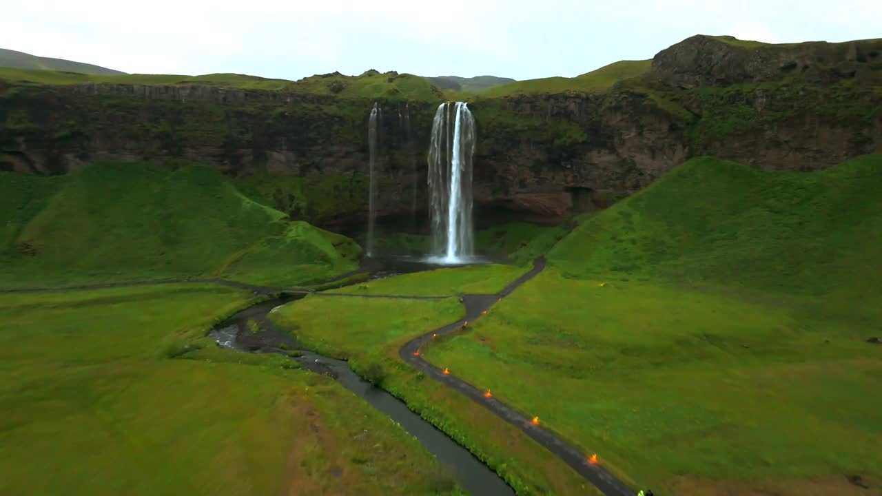 This drone footage captures the magic of Seljalandsfoss, showcasing its unique vantage points and the lush landscape that surrounds it.