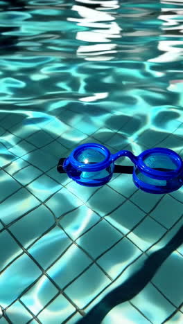 blue swimming goggles in a pool