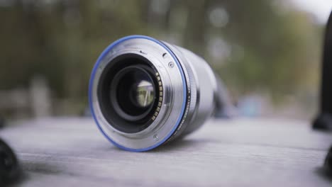 close up of opened aperture on camera lens. action. camera lens, details of professional equipment for photo and video shooting on blurred background